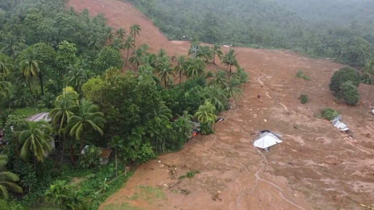 a huge swathe of brown earth across a forested hillside in Baybay where villages were buried in Tropical Storm Megi