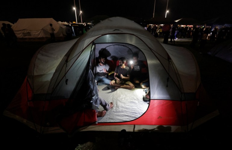 Demonstrators play music inside a tent at a protest area, dubbed the Gota-Go village, 