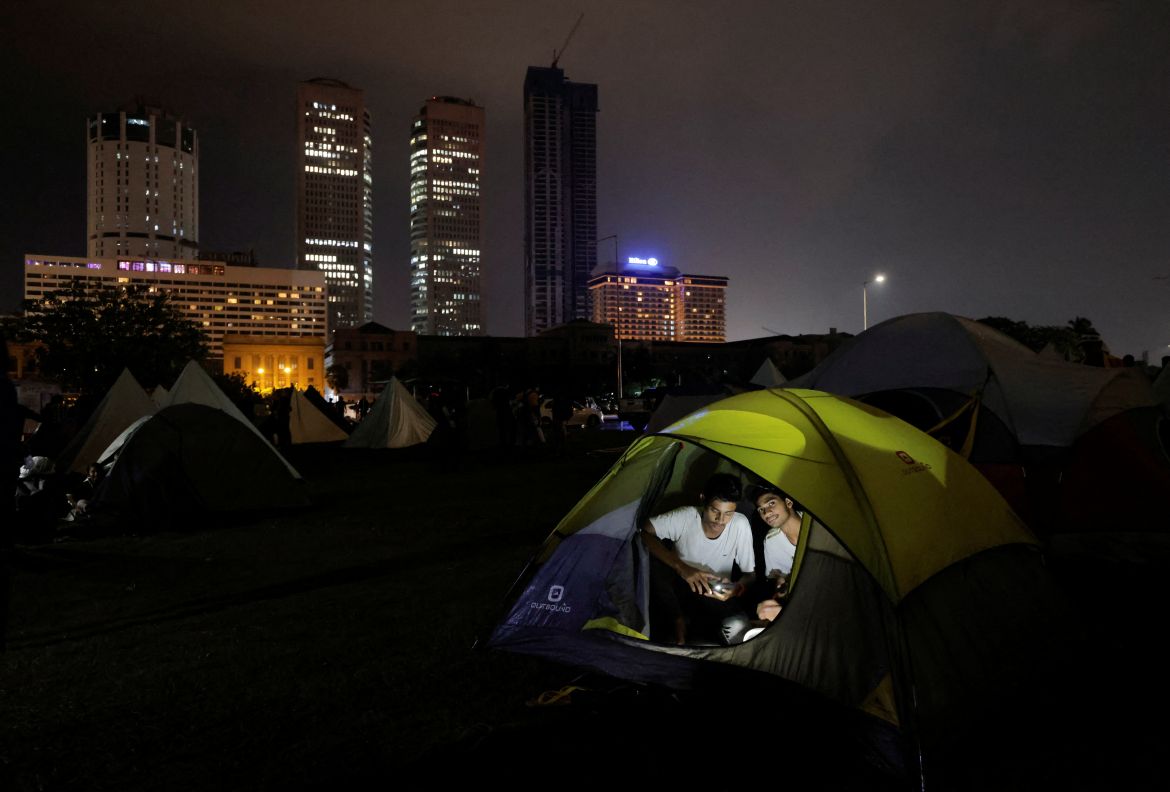 Demonstrators sit inside a tent at a protest area, dubbed the Gota-Go