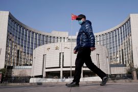 A man walks by China's central bank.