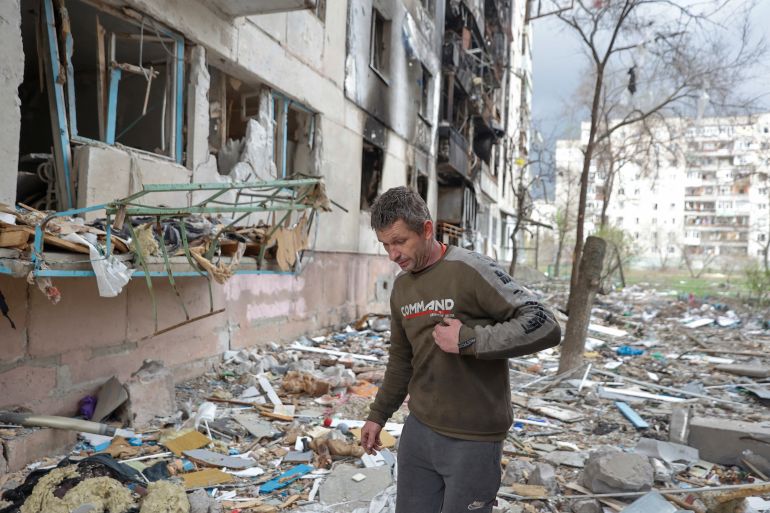 Local resident Viacheslav walks on debris of a residential building damaged by a military strike, as Russia's attack on Ukraine continues, in Sievierodonetsk, Luhansk region, Ukraine April 16, 2022.