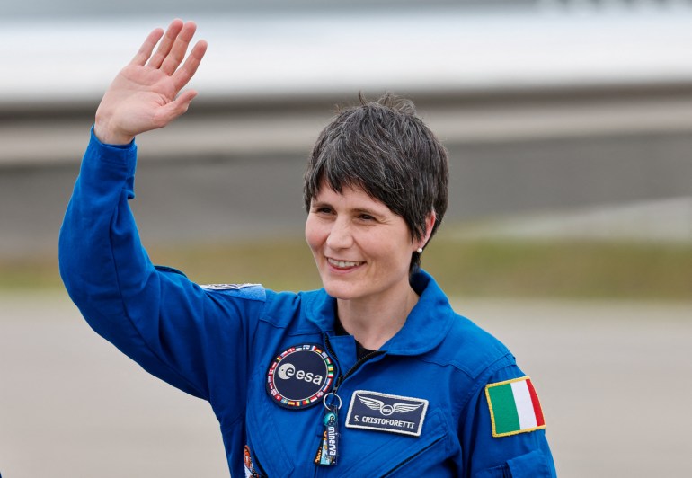 European Space Agency astronaut Samantha Cristoforetti, dressed in blue jumpsuit with an Italian flag on her sleeve, waves to well wishers ahead of the launch to the ISS