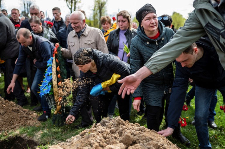 People attend the funeral of Ukrainian serviceman Andriy Butrik, 47, who was killed by a Russian shelling in Kurulka village in Kharkiv Region, amid Russia's invasion of Ukraine, in Zhytomyr, Ukraine 