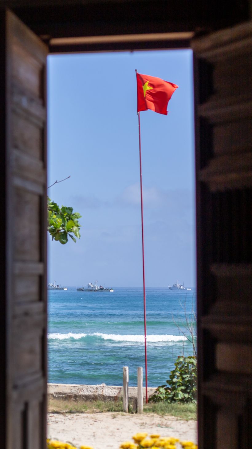 A photo from the steps of one of Ly Son’s whale temples with numerous Vietnamese coast guard vessels standing guard in the view,