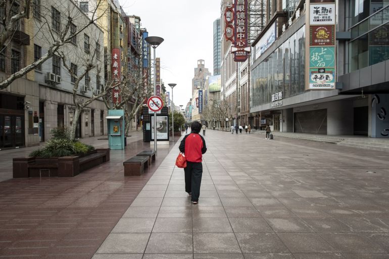 A person walks down a deserted Shanghai street.