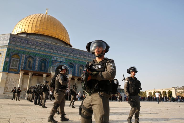 Israeli border police officers stand next to the Al Aqsa Mosque compound