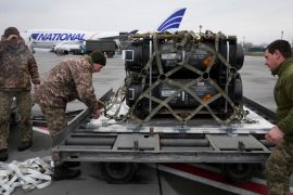Ukrainian servicemen unpack shipment of military aid delivered as part of the US' security assistance to Ukraine, at the Boryspil airport, outside Kyiv [File: Efrem Lukatsky/AP]