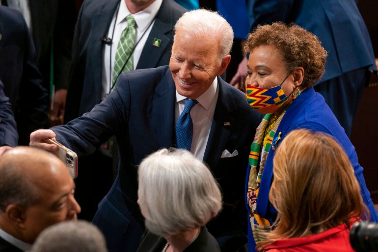 President Joe Biden takes a selfie with Representative Barbara Lee (D-CA) after delivering his first State of the Union address to a joint session of Congress at the Capitol.