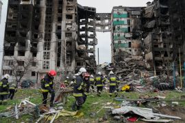 Emergency workers carry debris from a multi-storey building destroyed in a Russian air raid in Borodyanka, close to Kyiv, Ukraine.