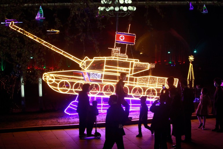 A tank decked out with lights - a North Korean flag at its turret - at an event to mark the birth of the country's founder Kim Il Sung