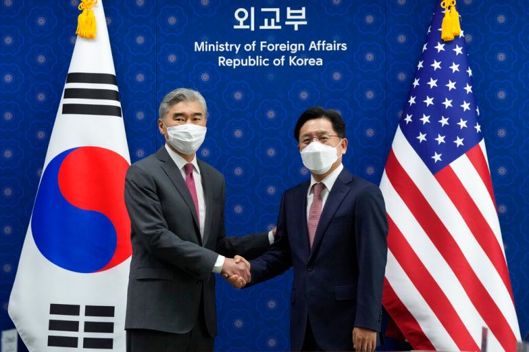 U.S. Special Representative for North Korea, Sung Kim, left, shakes hands with South Korea's Special Representative for the Korean Peninsula Peace and Security Affairs Noh Kyu-duk as they pose for a photo during a meeting at the Foreign Ministry in Seoul.