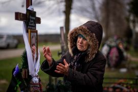 Valentyna Nechyporenko, 77, mourns at the grave of her 47-year-old son Ruslan, during his funeral at the cemetery in Bucha, on the outskirts of Kyiv, Ukraine.