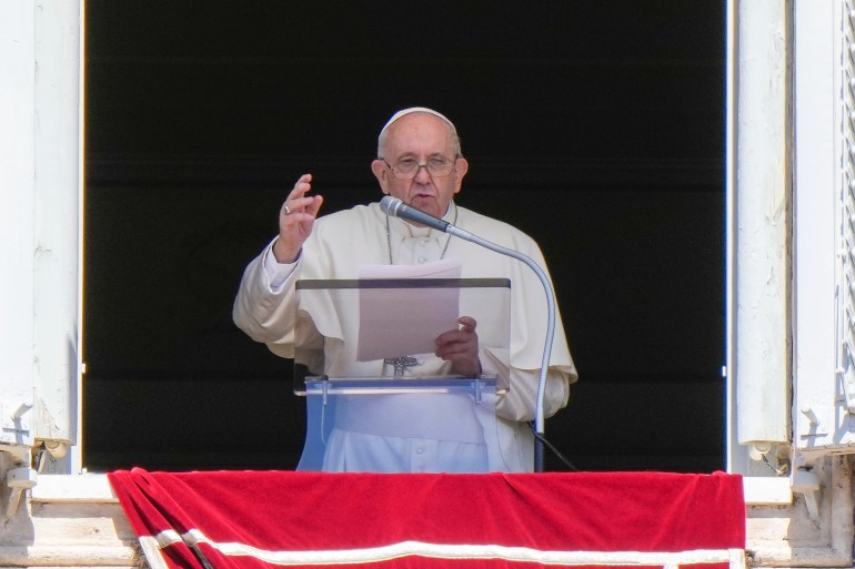 Pope Francis delivers his blessing as he recites the Regina Coeli noon prayer from the window of his studio overlooking St.Peter's Square, at the Vatican.