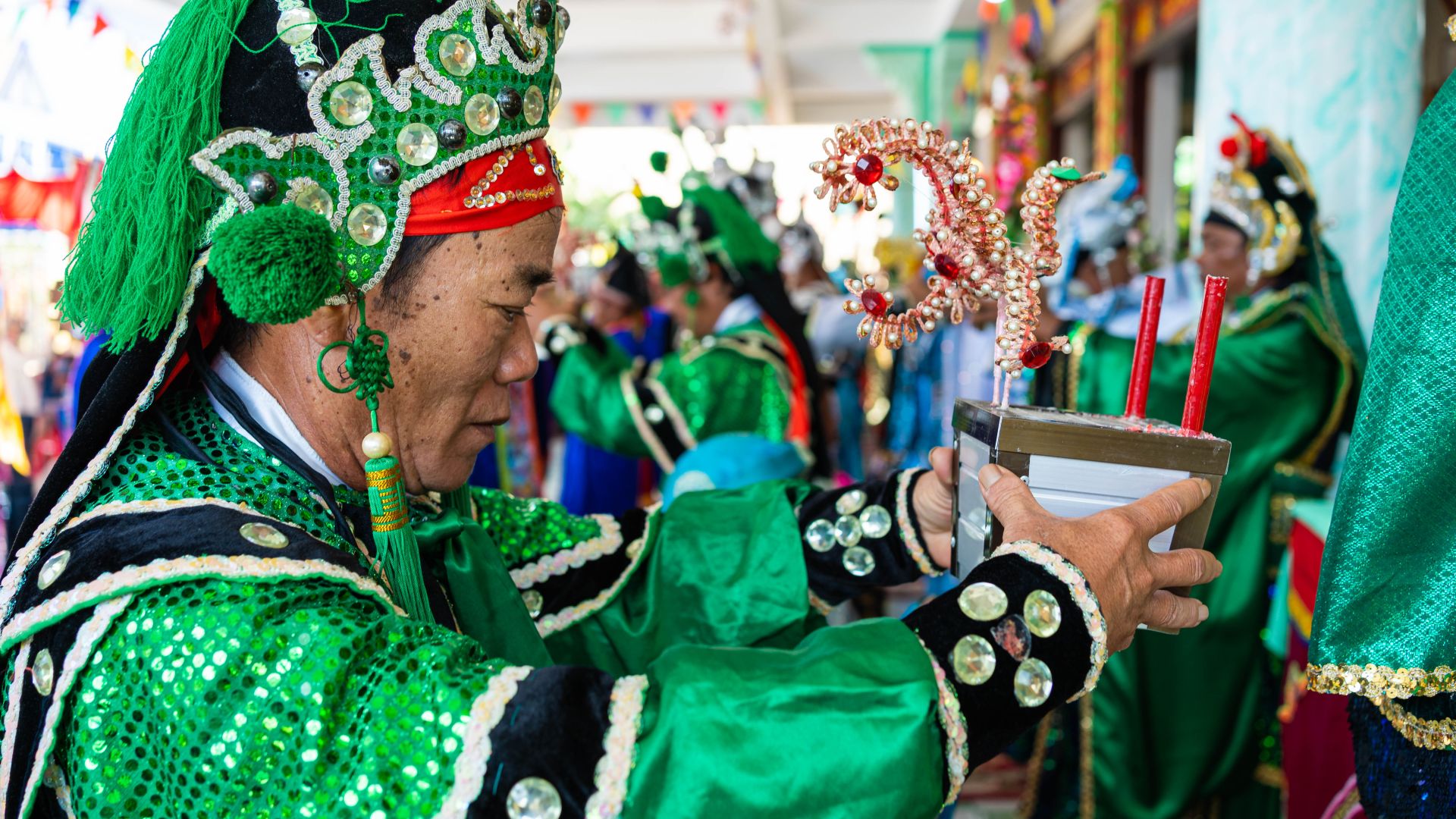A photo of whale worshippers in elaborate dress carrying candles and flowers as offerings during Phuoc Hai’s whale worship festival.