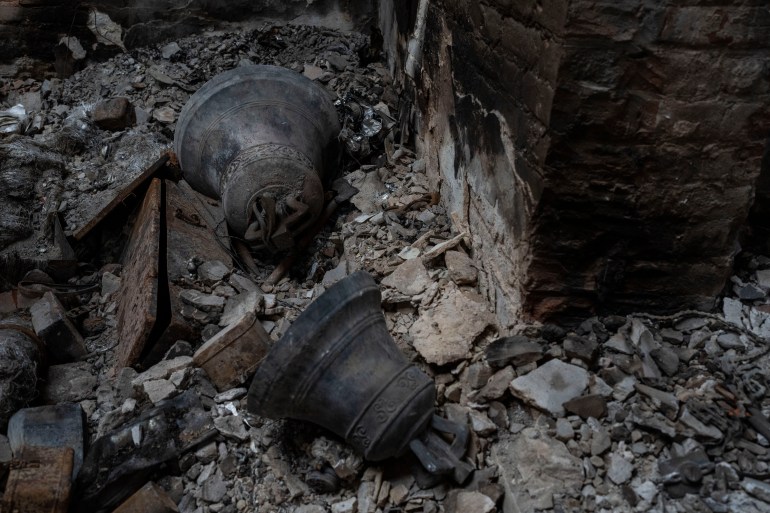 Bells of the church in Lukashivka, in northern Ukraine, lying in a heap of rubble from one of the church's domes