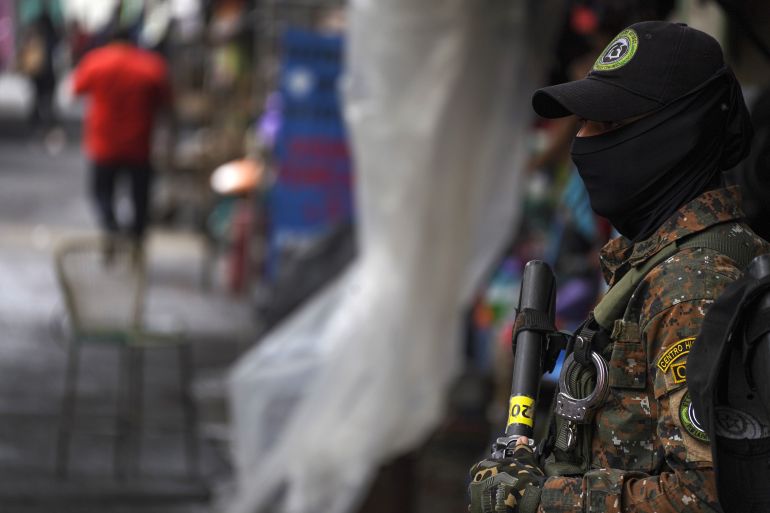An armed soldier stands guard in El Salvador