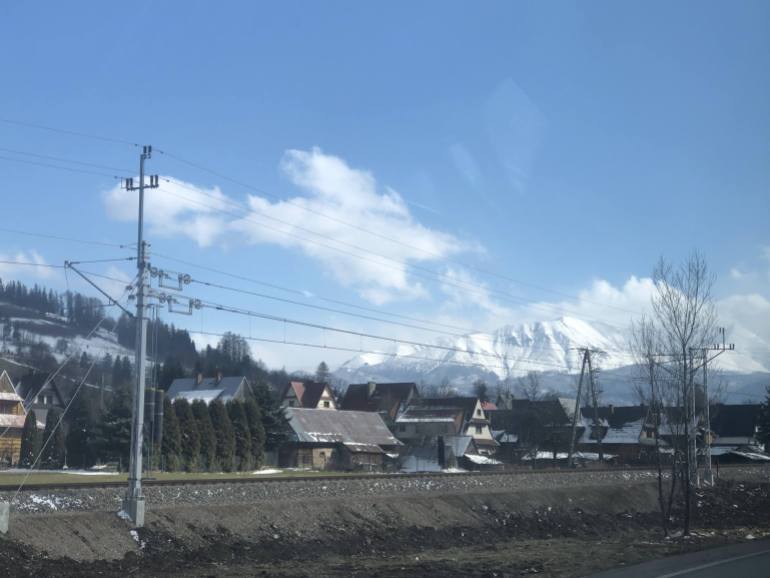 A photo of homes in Zakopane with Tatras Mountains on the horizon.