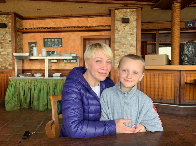 Svetlana Gololobova with her seven-year-old son, originally from Borodyanka, Ukraine, at the canteen of the Sunny Bay hotel [Antoaneta Roussi/Al Jazeera]