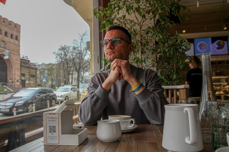 Andrew Radetsky sits in a cafe in Kyiv