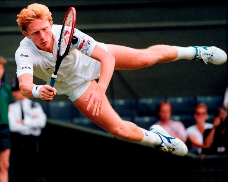 Boris Becker flies through the air to return a shot from Australia's Wally Masur during their second round match at Wimbledon in 1990 [File photo: Dave Caulkin/AP]