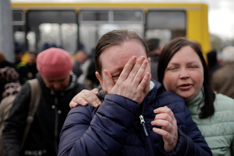 Ukrainian woman from Mariupol cries after safely arriving in Zaporizhzhia in a small convoy that crossed through territory held by Russian forces.