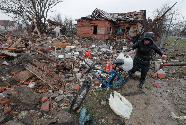epa09881341 A local woman tries to find her belongings in the debris of her shelled house on the outskirt of Chernihiv city, Ukraine, 09 April 2022. Some cities and villages had recently been recaptured by the Ukrainian army from Russian forces and now people try to restore normal life there. Russian troops entered Ukraine on 24 February resulting in fighting and destruction in the country and triggering a series of severe economic sanctions on Russia by Western countries. EPA-EFE/SERGEY DOLZHENKO