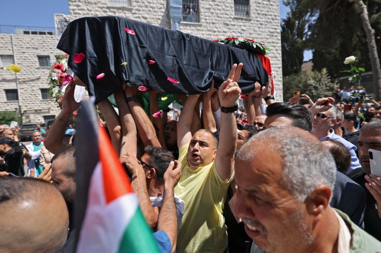 Abu Akleh's coffin is carried by mourners