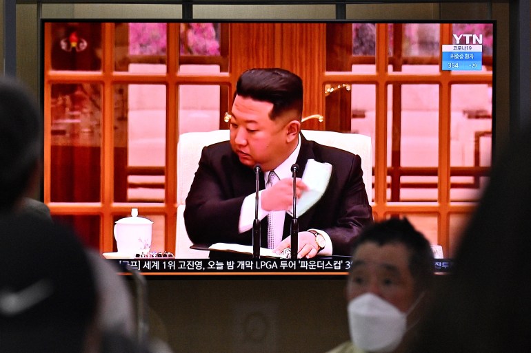 Kim Jong Un shown on North Korean state television removing his face mask