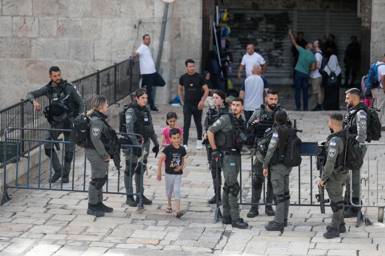 Members of Israeli security clear people away from Jerusalem's Damascus Gate