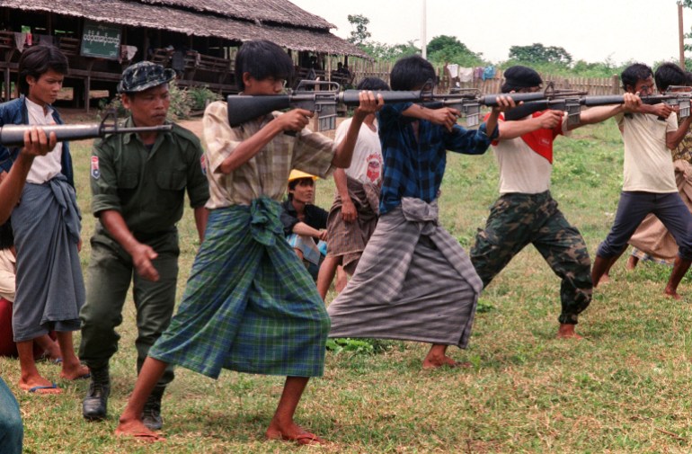 Burmese students wearing traditional longyi (sarong-type wraps) get training from Karen rebels in 1988