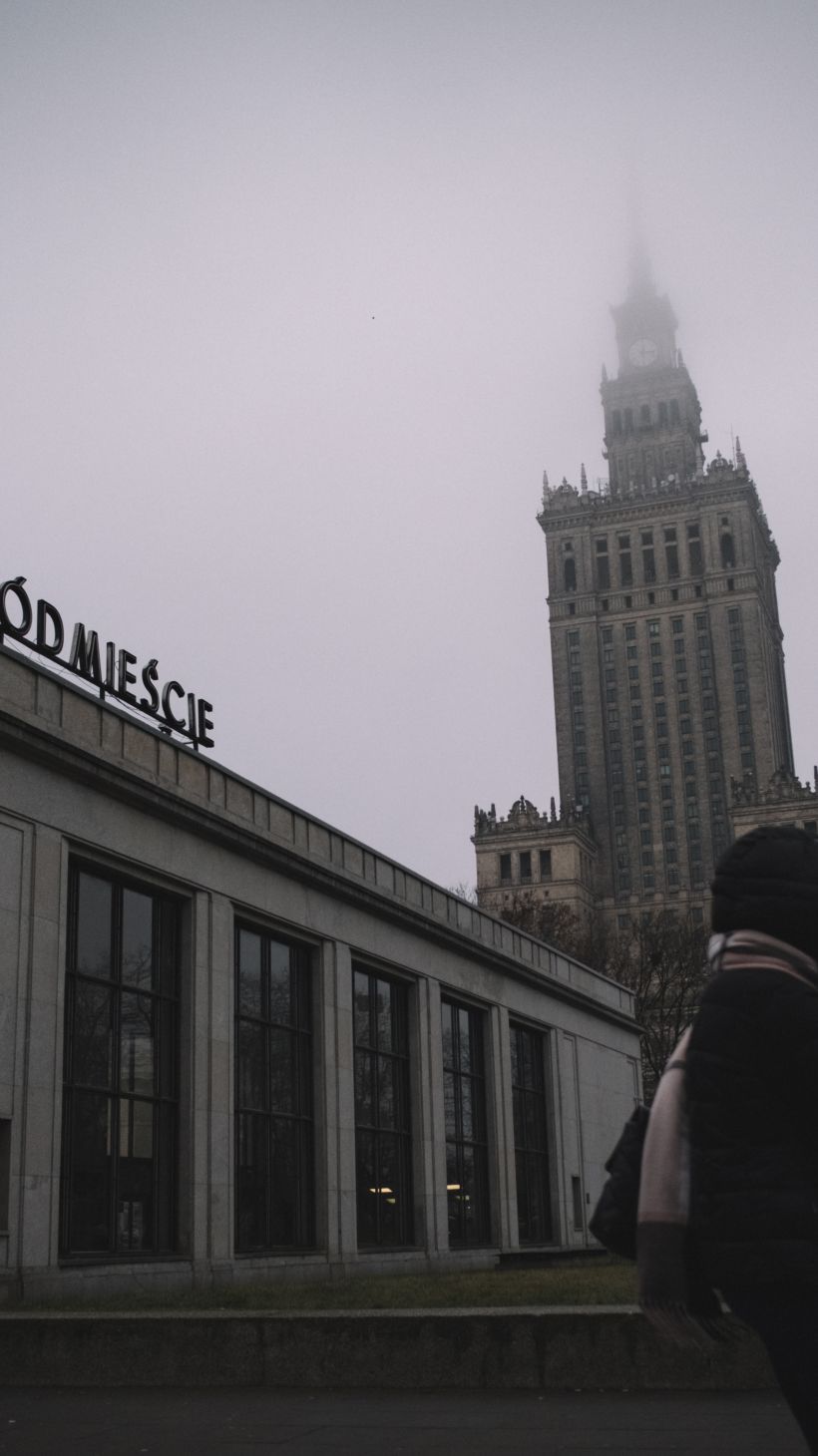 A young woman walks near by the Palace of Culture and Sciences in downtown Warsaw