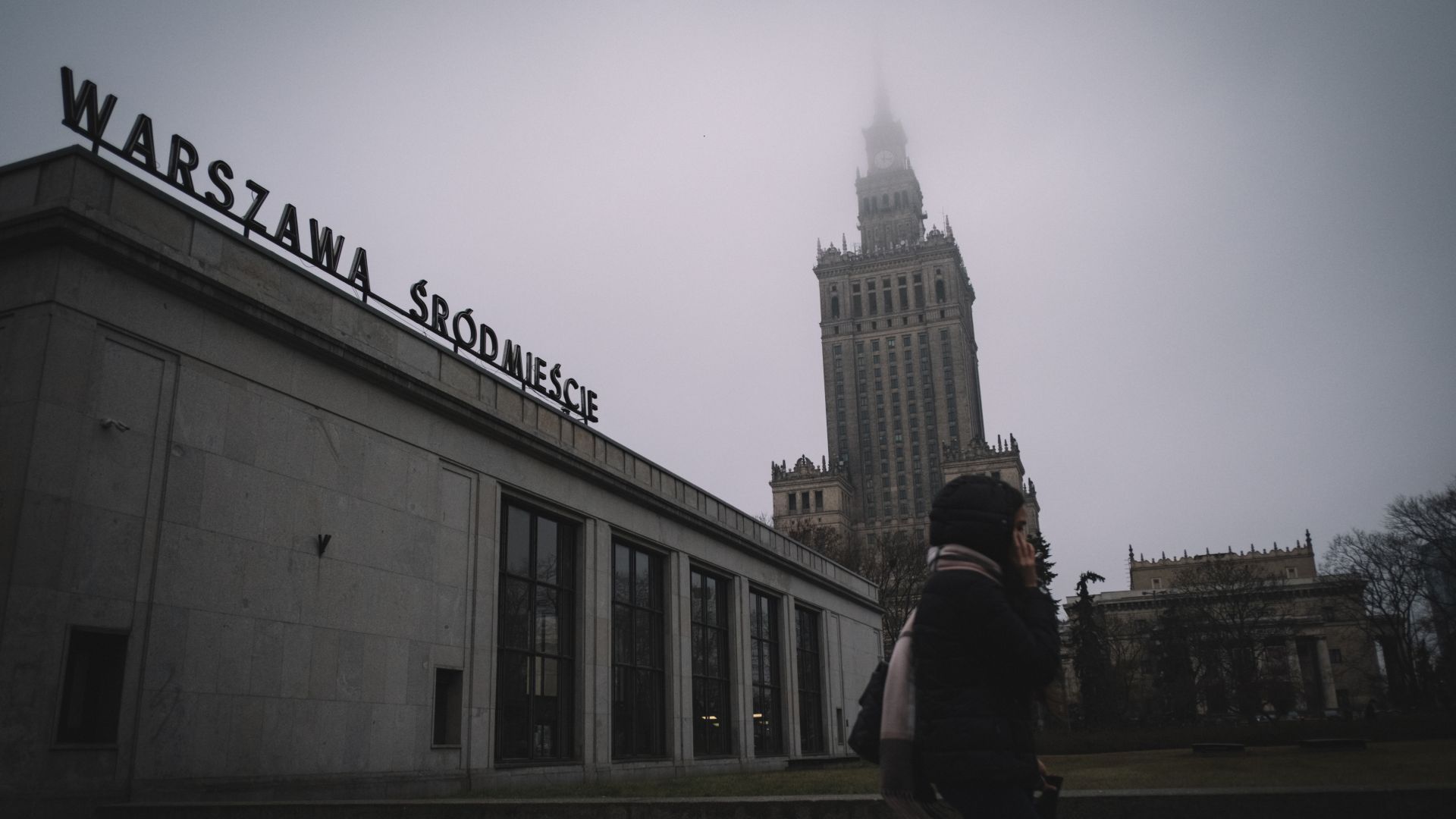 A young woman walks near by the Palace of Culture and Sciences in downtown Warsaw
