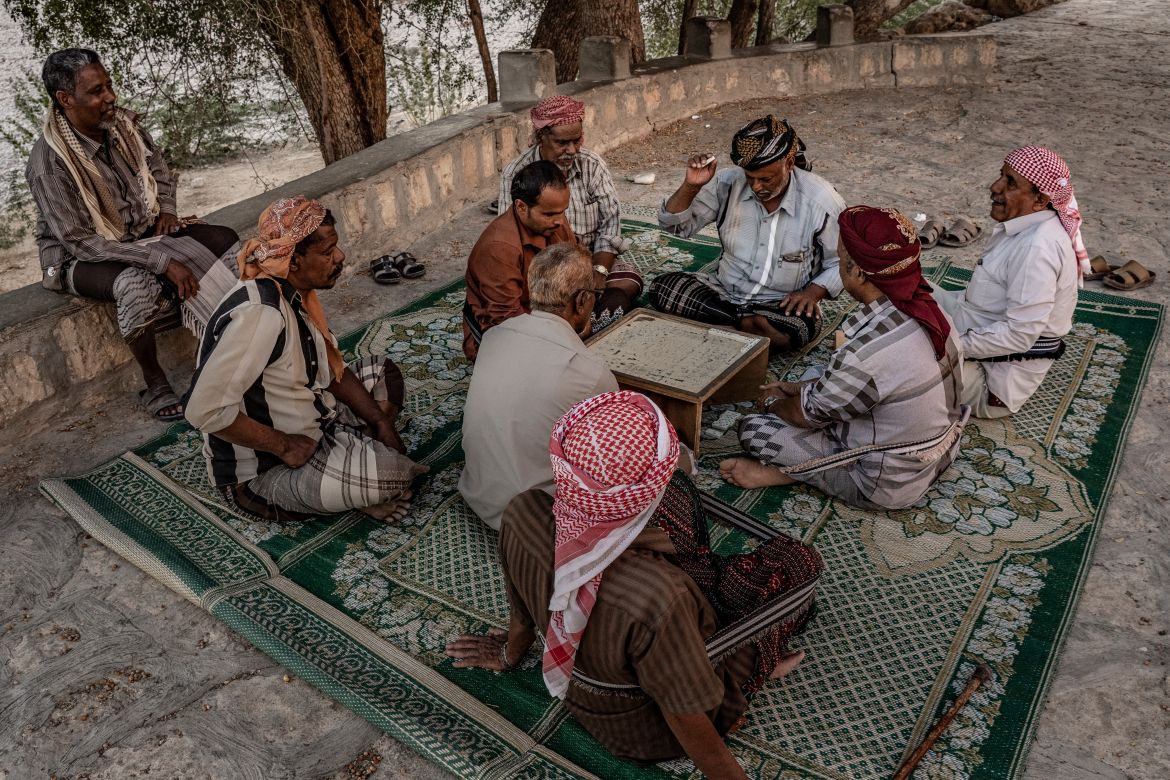Men play a board game at sunset in Wadi Dawan, near Haid al-Jazil village.