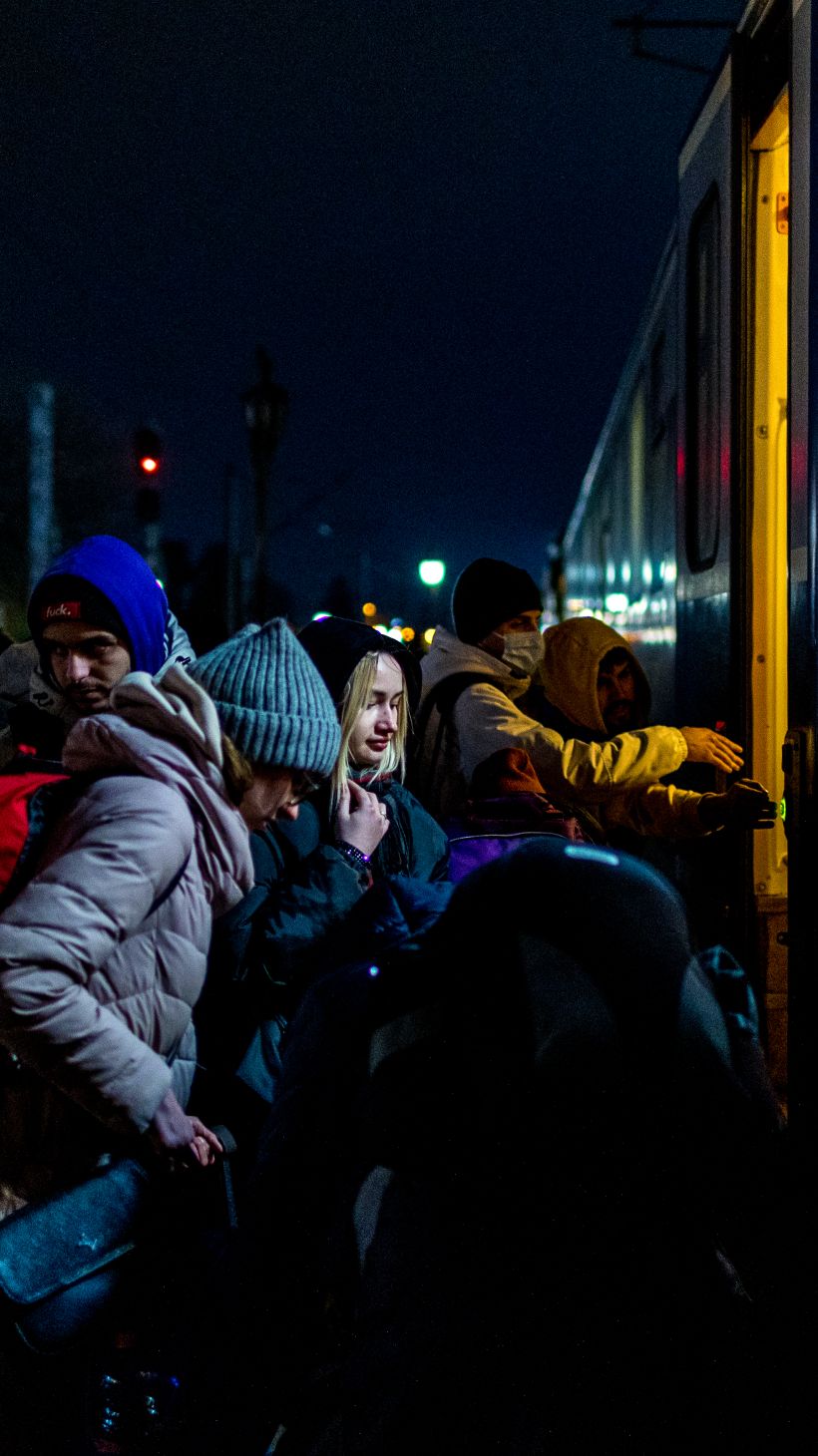 People wait to board a train