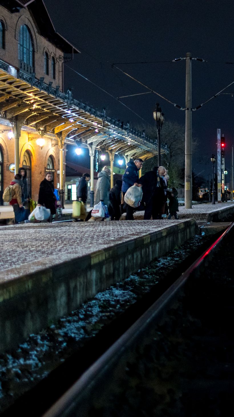 People wait on a train platform