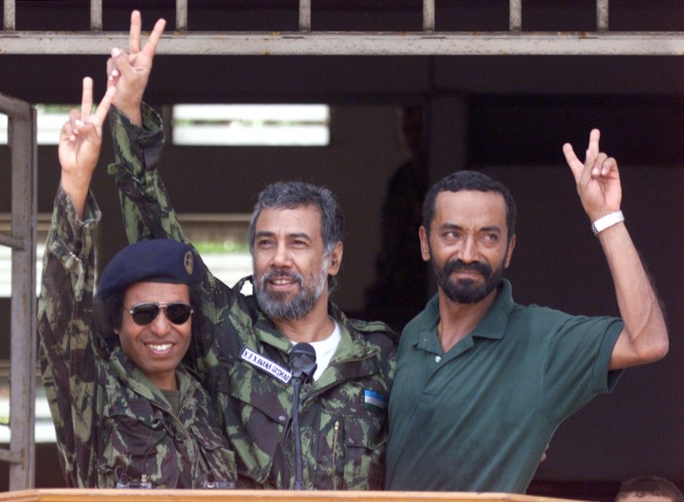 Xanana Gusmao, wearing fatigues, waves to the crowd as he returns to Timor in 1999 after being jailed in Indonesia