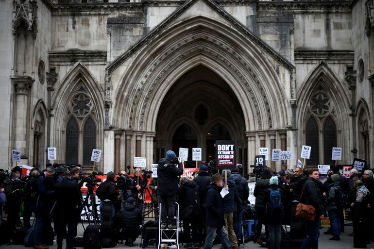 Supporters of WikiLeaks founder Julian Assange protest outside the Royal Courts of Justice in London.