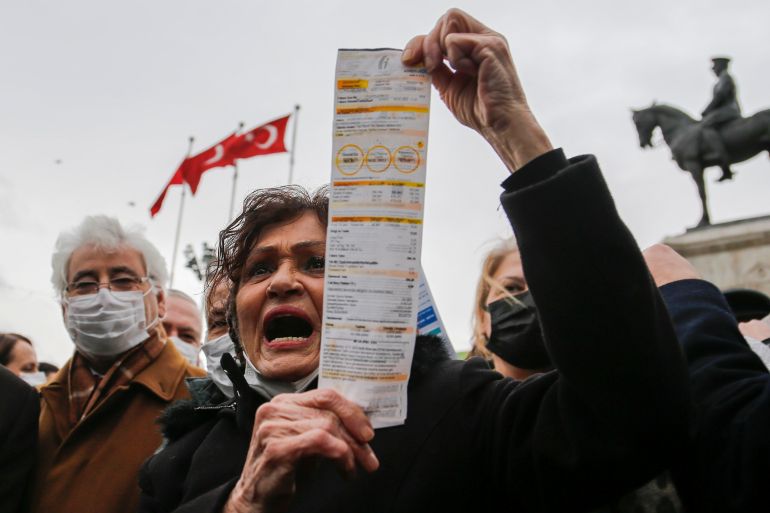 A woman displays her electricity bill during a protest against high energy prices in Ankara, Turkey February 9, 2022.