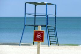 A mine warning sign is seen on a beach, amid Russia's invasion of Ukraine, in Odesa,