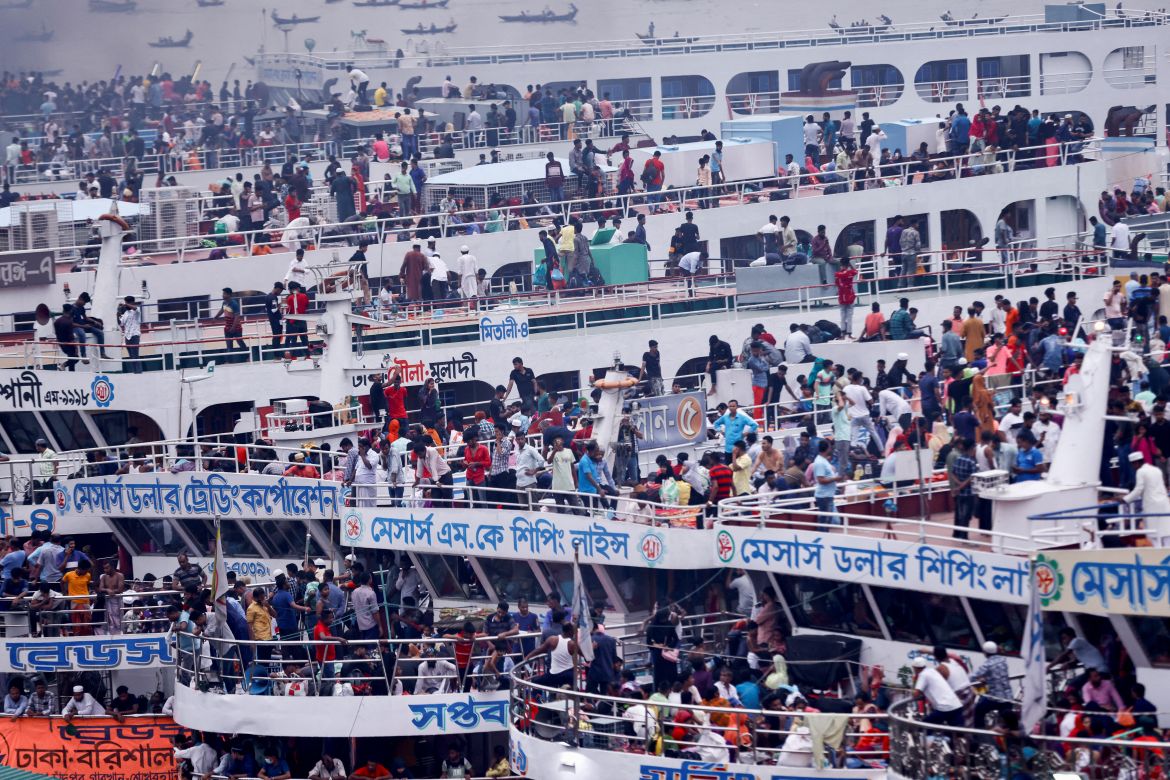 People sit onboard passenger ferries to travel home to celebrate Eid al-fitr, at the Sadarghat Launch Terminal, in Dhaka