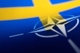 Swedish and NATO flags are seen printed on paper
