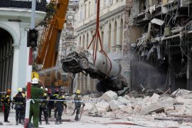 A gas tanker truck is lifted from debris after an explosion hit the Hotel Saratoga, in Havana