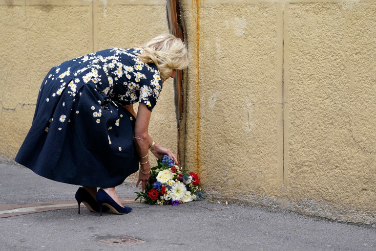 US First Lady Jill Biden places flowers at a memorial dedicated to the 26-year-old investigative journalist Jan Kuciak and his fiancée Martina Kusnirova, assassinated in their home in 2018