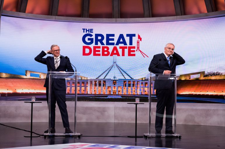 Anthony Albanese (left) and Scott Morrison (right) both adjust their hair as they appear on the 'great debate' on TV in the run-up to the election