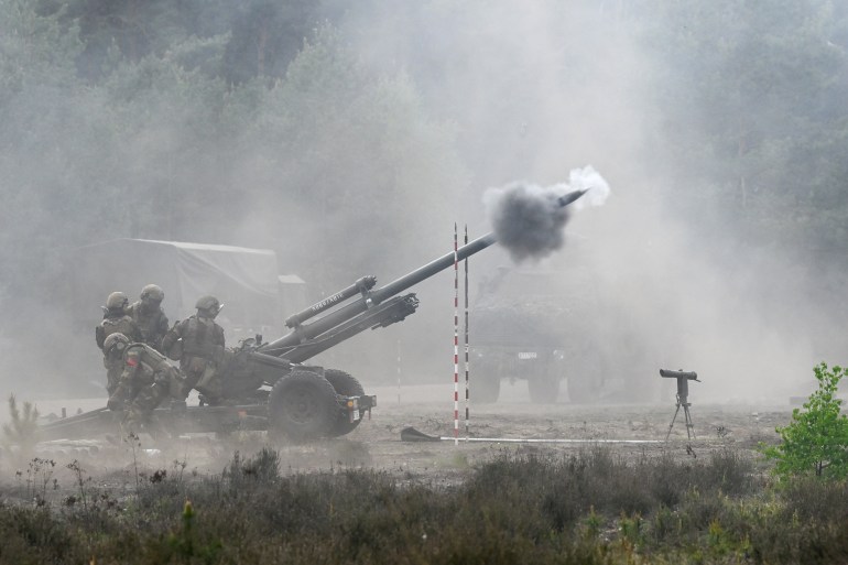 Soldiers shoot from a howitzer during training at a German army base on a NATO media day, in which up to 7,500 soldiers from 9 nations take part, in Munster, Germany.
