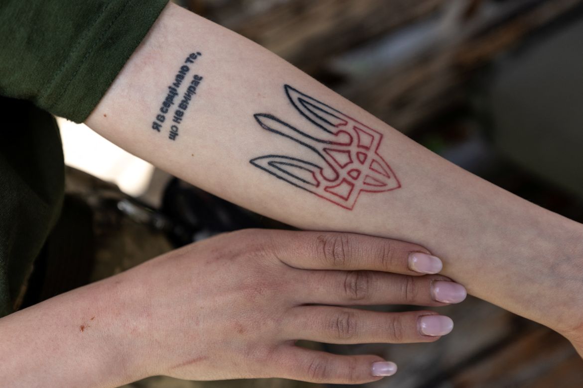 Ukrainian volunteer paramedic Aleksandra Pohranychna, 20, displays her tattoo of the Ukrainian coat of arms with with a quotation from the Ukrainian poet Lesya Ukrainka: “I have in my heart something that will never die.", while on duty, amid Russia's invasion in Ukraine, in Sviatohirks, Donetsk region