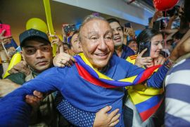 Colombian presidential candidate Rodolfo Hernandez walks through a crowd of supporters
