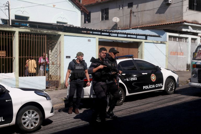 Police officers arrive at the Getulio Vargas Hospital, after more than eleven people were killed during a police operation against drug dealers in the Vila Cruzeiro slum, in Rio de Janeiro, Brazil May 24,