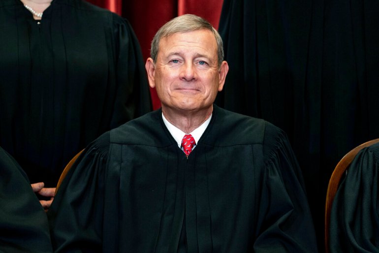 Chief Justice John Roberts sits during a group photo at the Supreme Court in Washington., DC