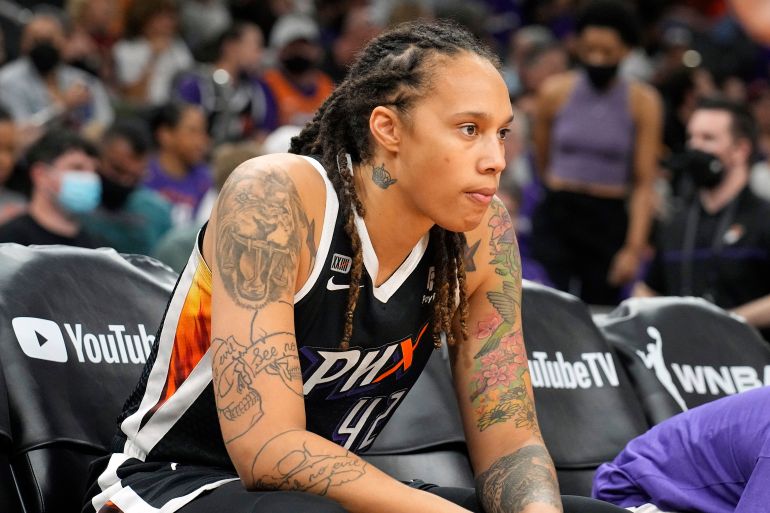 Brittney Griner sitting on the sidelines of a basketball game in Phoenix, Arizona.